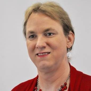 Image of Anna Dudda wearing red blouse and necklace. 